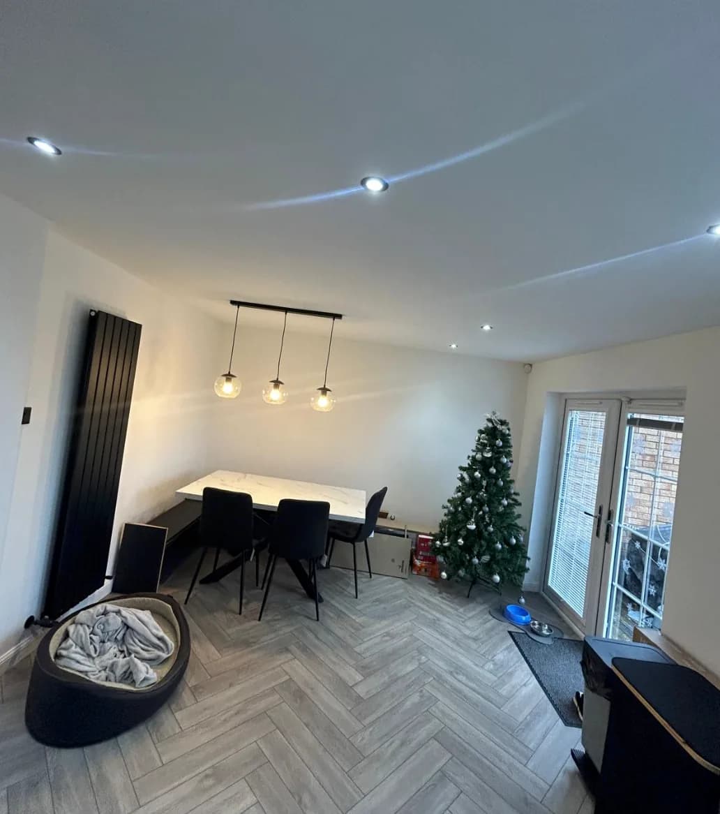 Dining room with three pendant lights and recessed ceiling downlights